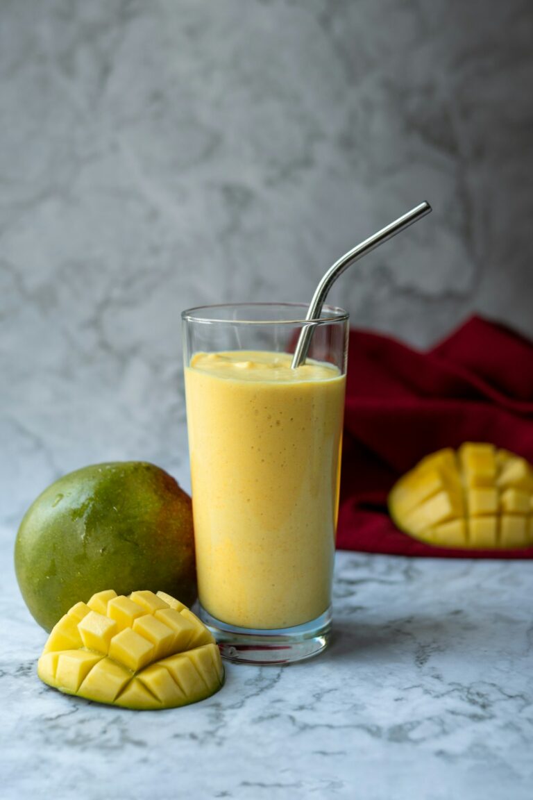 Illustrative photo of a glass of mango lassi with fresh mango